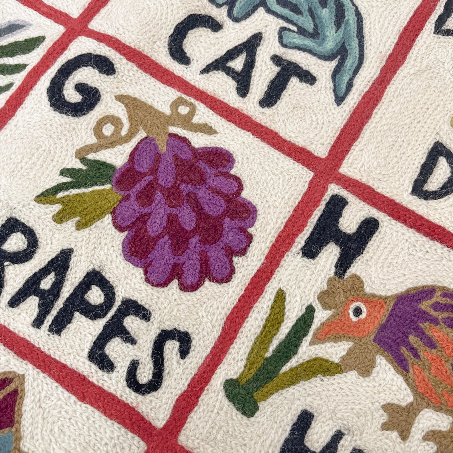 Alphabet pattern hand embroidered rug